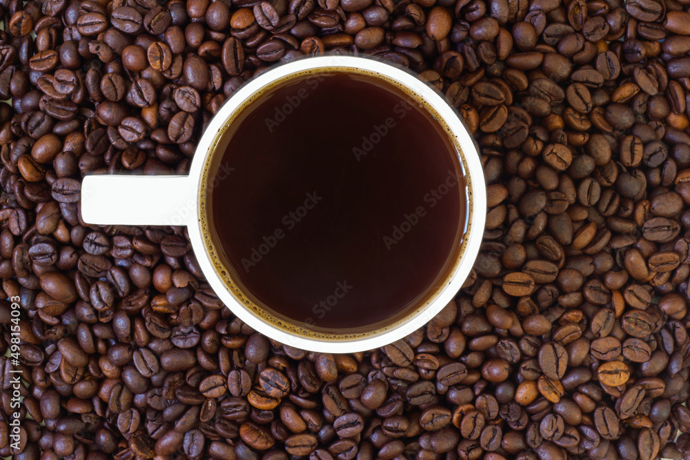 coffee beans in the cup and in the background coffee beans in the cup and in the background