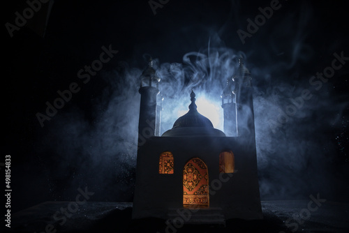 A realistic Mosque miniature with windows at night. Festive greeting card, invitation for Muslim holy month Ramadan Kareem.