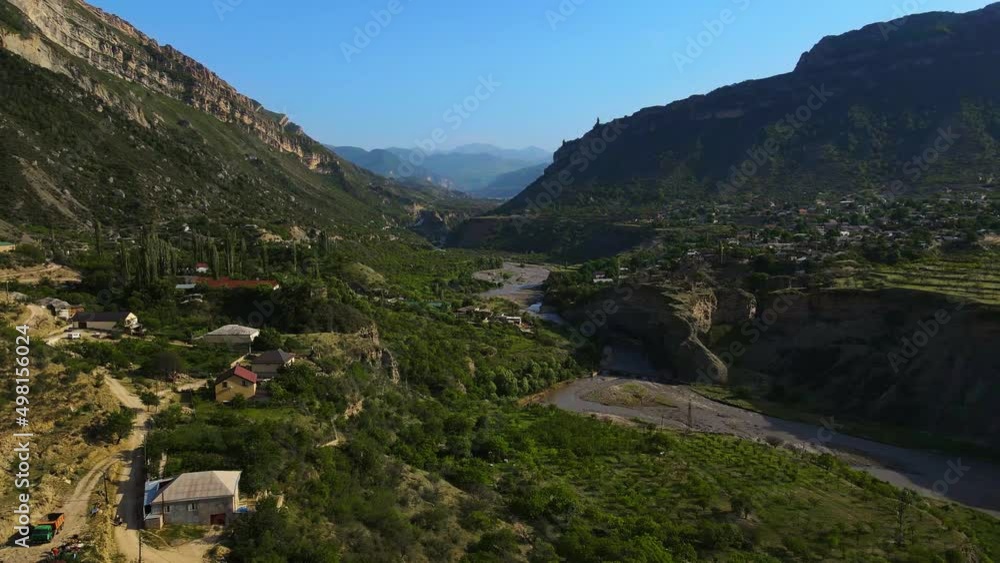 A mountain river with turquoise water flows along the bottom of the gorge A mountain river with turquoise water flows along the bottom of the gorge