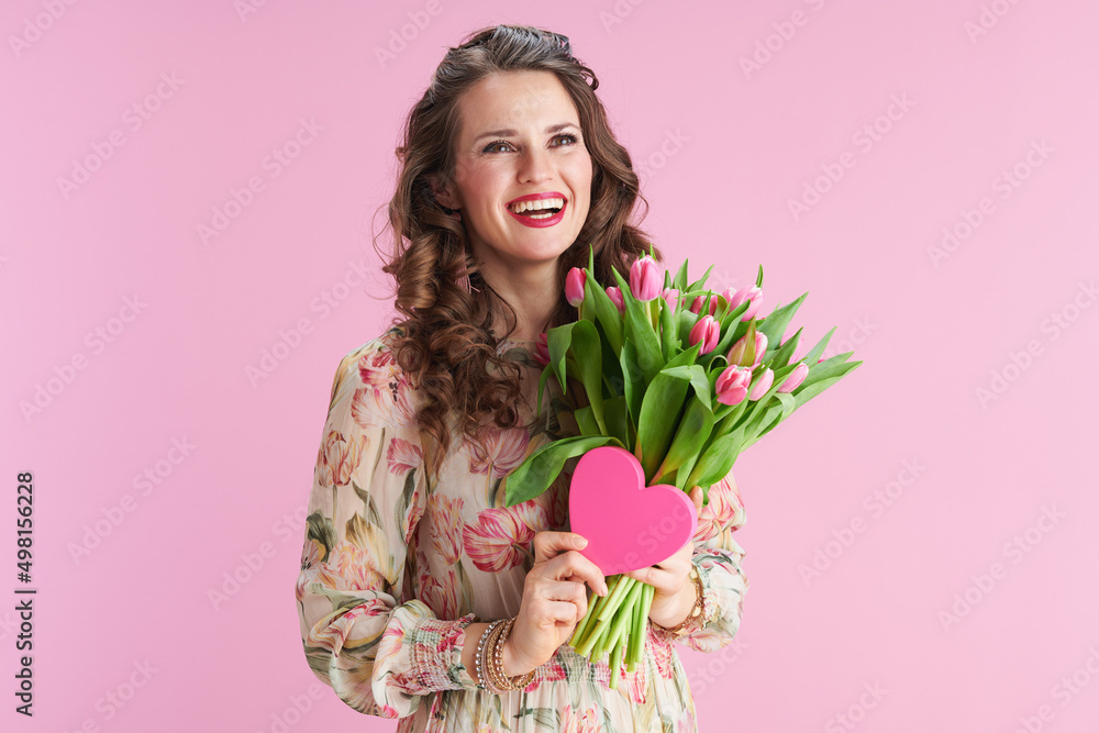 smiling stylish woman with long wavy brunette hair on pink smiling stylish woman with long wavy brunette hair on pink