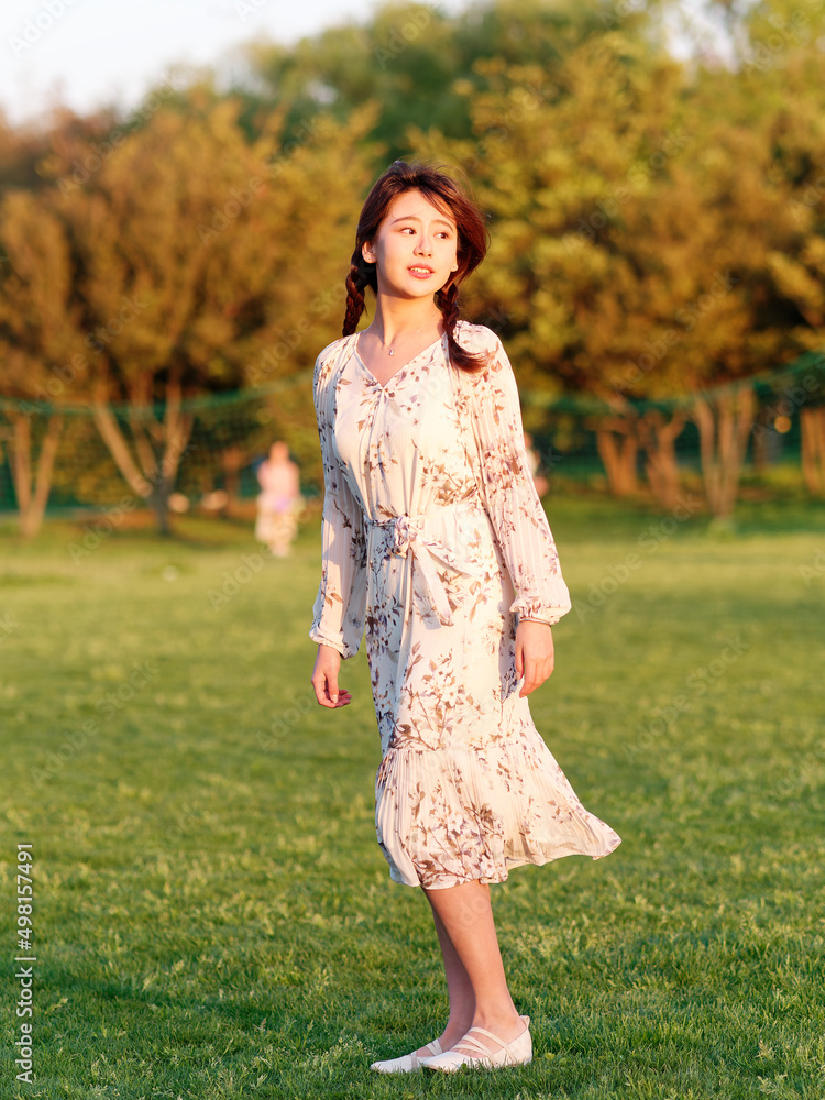 Portrait of elegant Chinese girl in dress enjoy carefree time in forest park in sunny day. Outdoor fashion portrait of glamour young Chinese cheerful stylish woman. Portrait of elegant Chinese girl in dress enjoy carefree time in forest park in sunny day. Outdoor fashion portrait of glamour young Chinese cheerful stylish woman.
