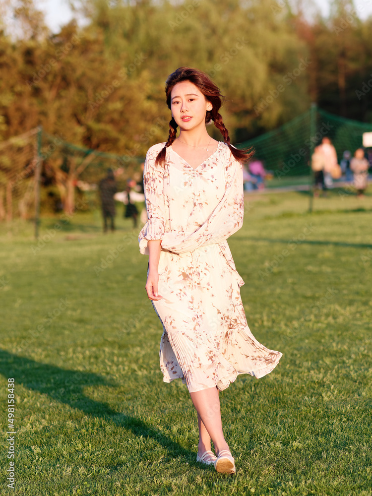 Portrait of elegant Chinese girl in dress enjoy carefree time in forest park in sunny day. Outdoor fashion portrait of glamour young Chinese cheerful stylish woman. Portrait of elegant Chinese girl in dress enjoy carefree time in forest park in sunny day. Outdoor fashion portrait of glamour young Chinese cheerful stylish woman.