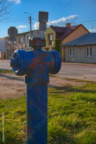 blue fire hydrant at sunrise with a blue sky background
