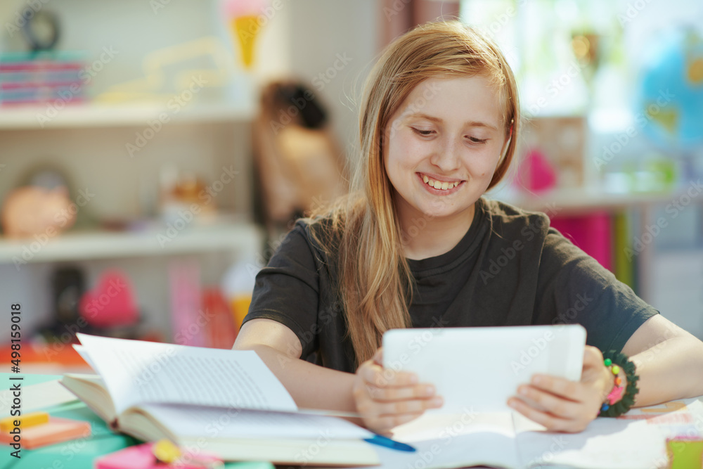 school girl having distance education at home in sunny day school girl having distance education at home in sunny day