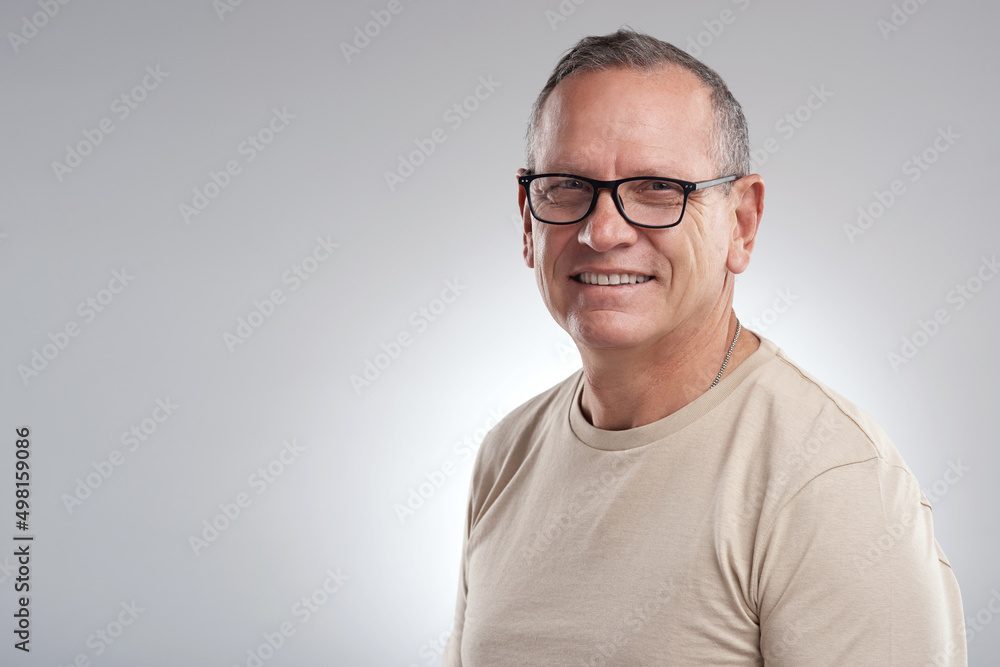 Wherever you stand, stand tall. Shot of a handsome mature man standing alone against a grey background in the studio during the day. Wherever you stand, stand tall. Shot of a handsome mature man standing alone against a grey background in the studio during the day.