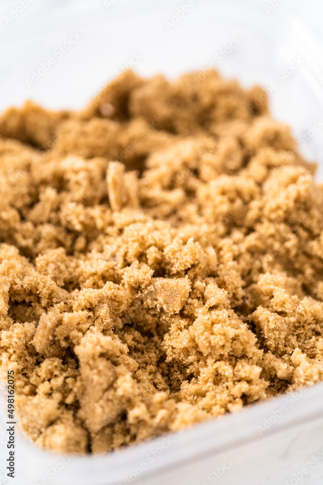 Light brown sugar in a glass container. Light brown sugar in a glass container.