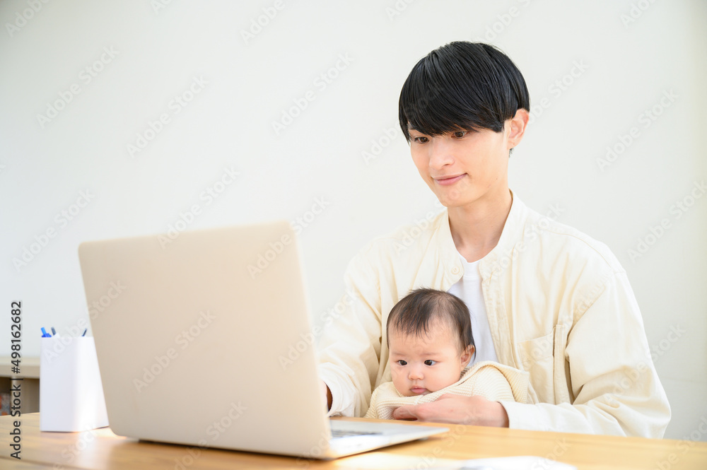 Young man working while holding baby Backlit Young man working while holding baby Backlit