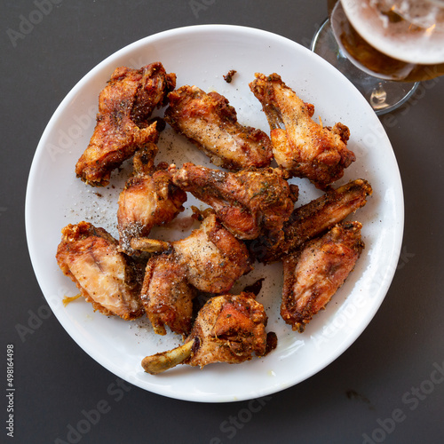 Plate with hot spicy homemade baked chicken wings