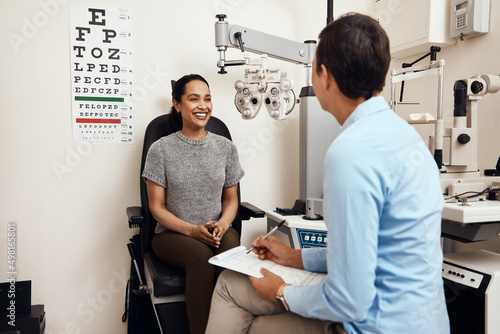 Is this the first eye test youve had. Shot of a young woman having an eye exam by an optometrist. photo