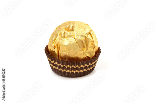 Round candy in a gold package and a paper capsule for a mini cupcake.