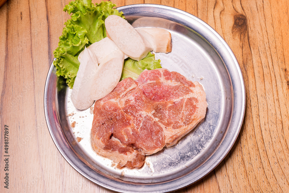 Raw pork on plate, Korean traditional style fresh pork beef belly BBQ, Japanese meat hot pot or Shabu in the restaurant, barbecue food Raw pork on plate, Korean traditional style fresh pork beef belly BBQ, Japanese meat hot pot or Shabu in the restaurant, barbecue food