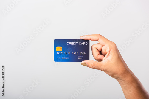 Close up hand of Asian woman she holding bank credit card for pay money online shopping, studio shot isolated on white background
