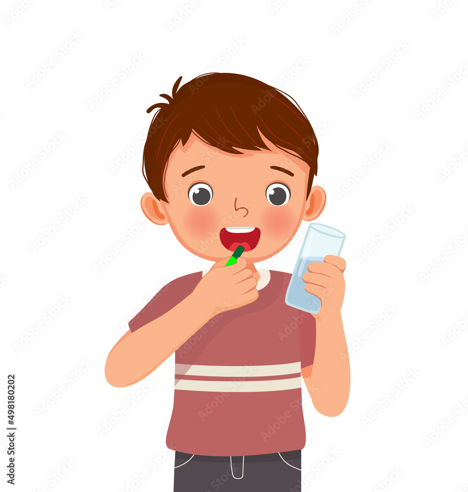 cute little boy taking a medicine capsule with a glass of water cute little boy taking a medicine capsule with a glass of water