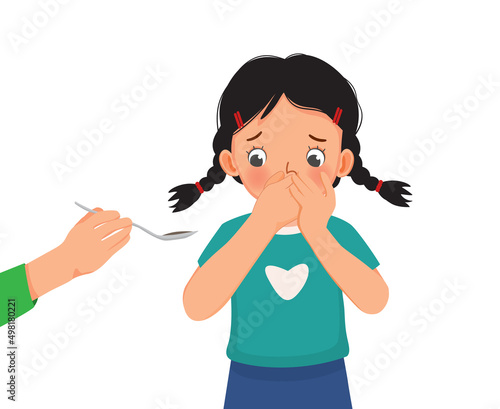 cute little girl refuses to take medicine syrup her mother giving her by covering her mouth with hands