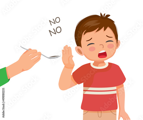 sick little boy refuses to take medicine or pills