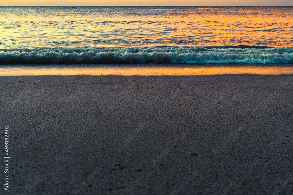 Beautiful reflection of golden color of sunset on the water at he beach Beautiful reflection of golden color of sunset on the water at he beach