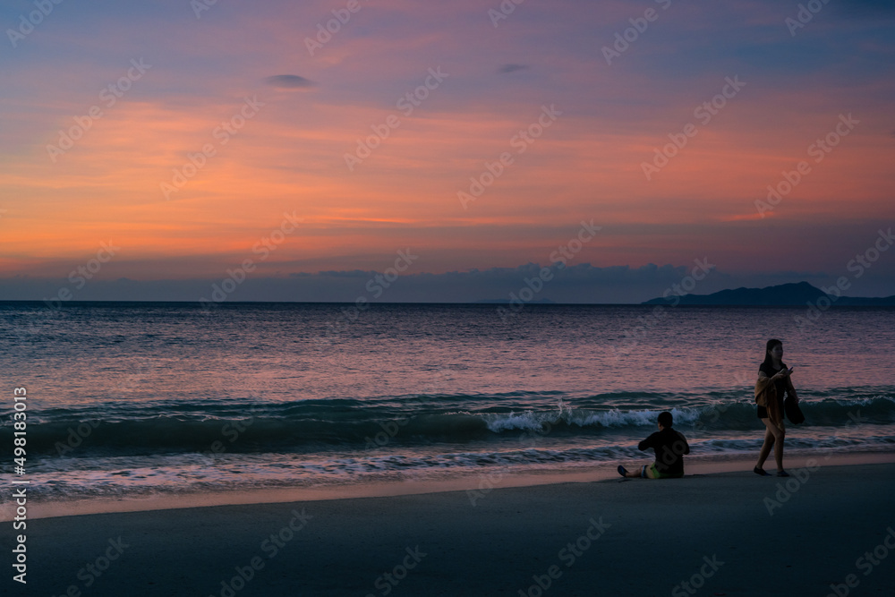 Enjoying summer at the beach of Puerto Galera, Philippines at sunset