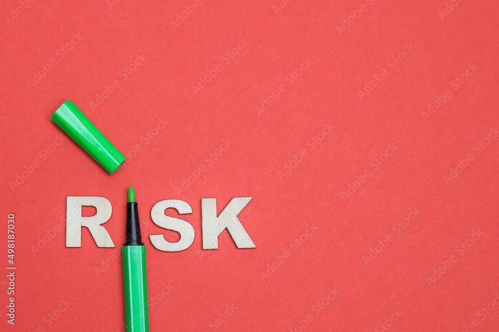RISK concept. Word on RISK with a pen replacing the letter "I" isolated ...