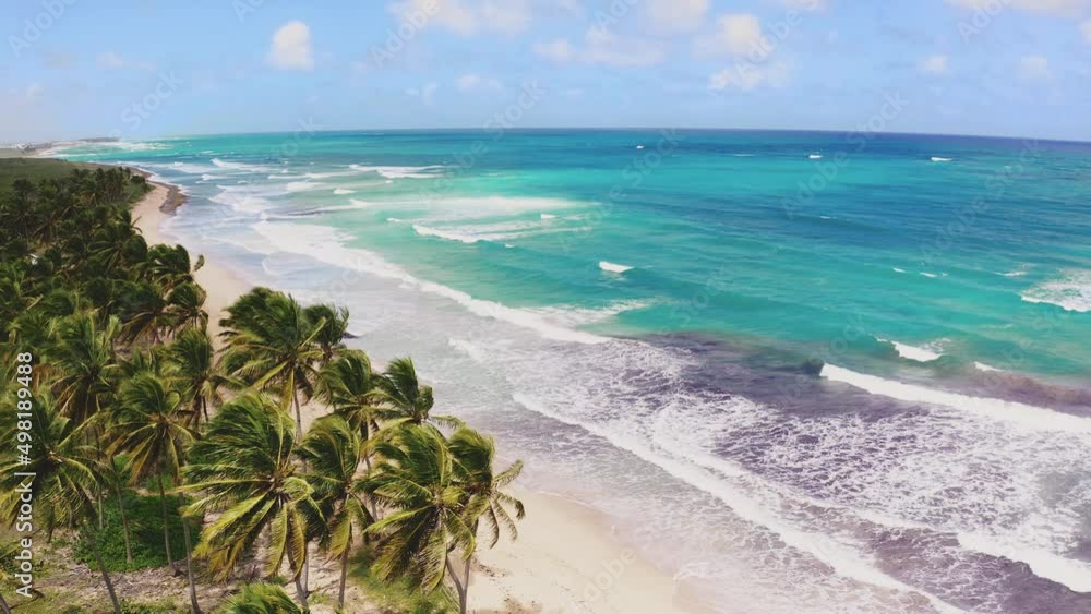 Calm waves of the Caribbean Sea near a palm beach on a summer sunny day. Seascape. Wildlife of the tropical coast. Blue cloudy sky over the ocean. Boat trip. Calm waves of the Caribbean Sea near a palm beach on a summer sunny day. Seascape. Wildlife of the tropical coast. Blue cloudy sky over the ocean. Boat trip.