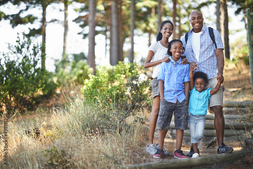 We all love a good walk in the forest. Portrait of an african american family enjoying a day out in the forest.