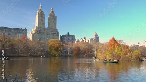 People enjoy sunny autumn day on the lake in Central park, New York city, USA