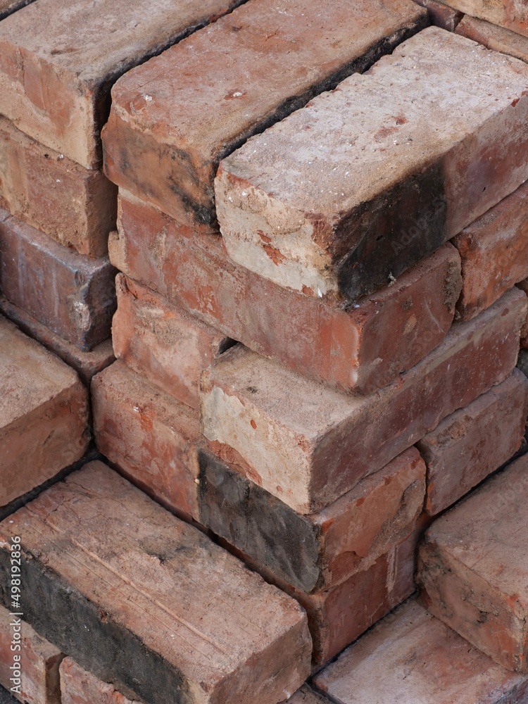 An isometric stack of various reclaimed house bricks An isometric stack of various reclaimed house bricks