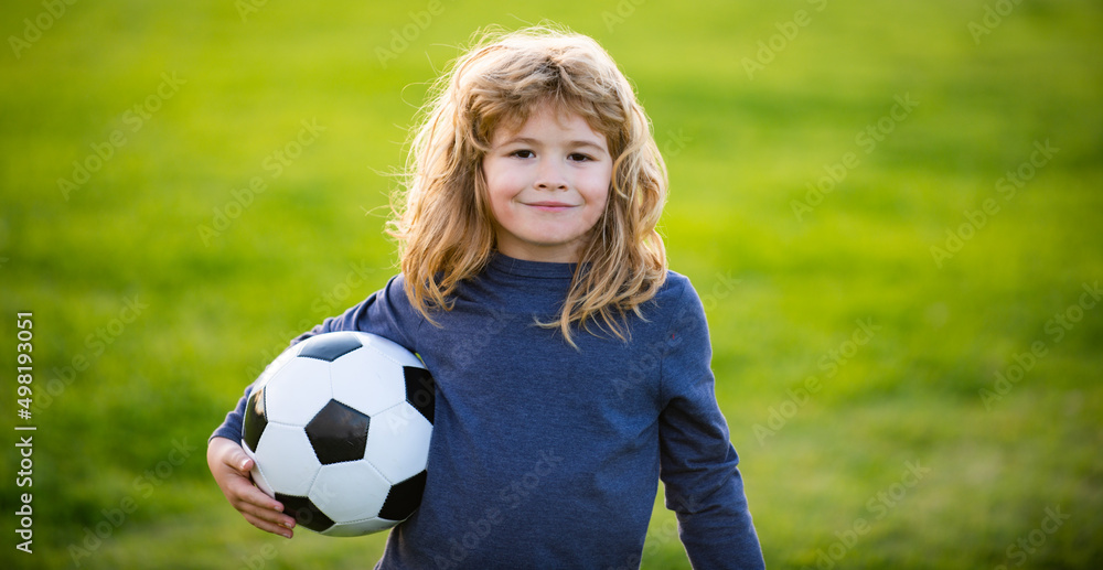 Young soccer player in sportswear with soccer ball. Cheerful little boy enjoy soccer, football sport games. Kid holding ball, closeup kids portrait. Portrait of child boy holds a soccer ball. Young soccer player in sportswear with soccer ball. Cheerful little boy enjoy soccer, football sport games. Kid holding ball, closeup kids portrait. Portrait of child boy holds a soccer ball.