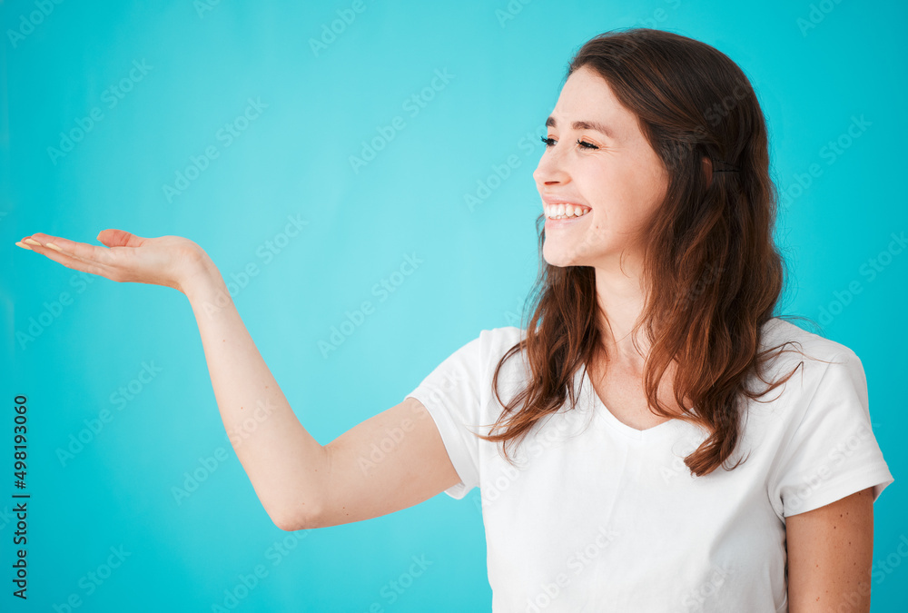 I swear by it. Studio shot of an attractive young woman posing with her hand out against a blue background. I swear by it. Studio shot of an attractive young woman posing with her hand out against a blue background.