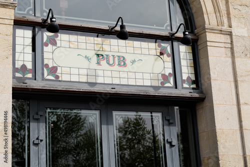 pub sign text on facade entrance bar city street storefront building
