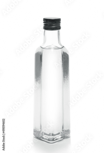 bottle of vodka or transparent drink, on white photo