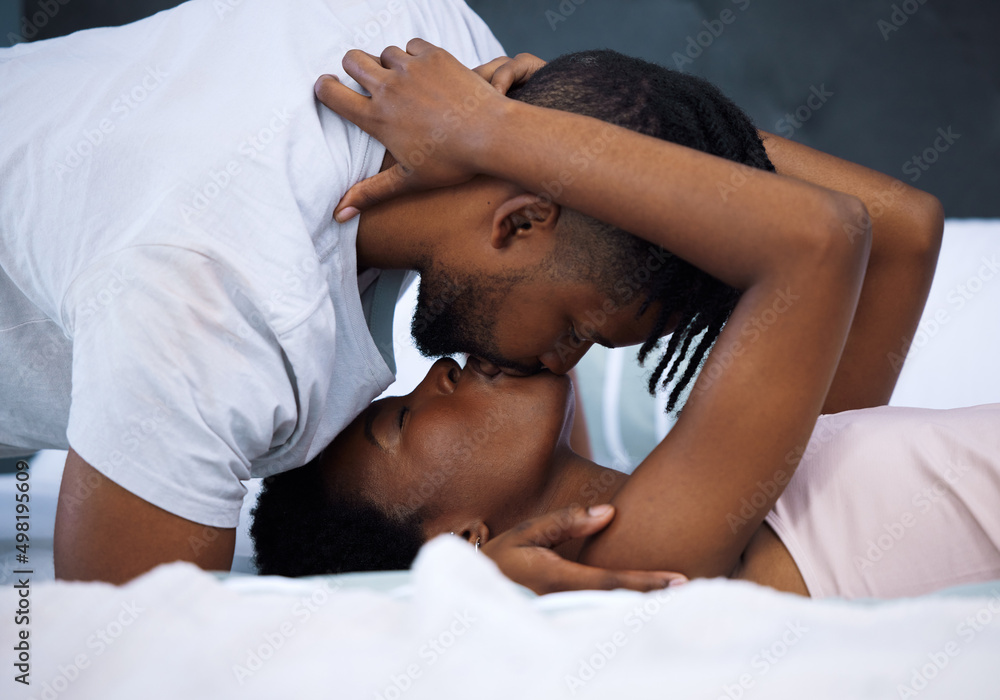 Soulmates say it without words. Shot of a young couple being intimate in bed at home. Soulmates say it without words. Shot of a young couple being intimate in bed at home.