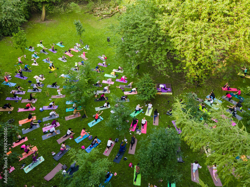 overhead view of people do yoga at city public park
