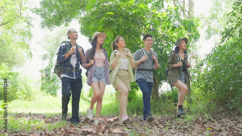 Group of Asian backpacker people have fun travel in forest together. Group of Asian backpacker people have fun travel in forest together.