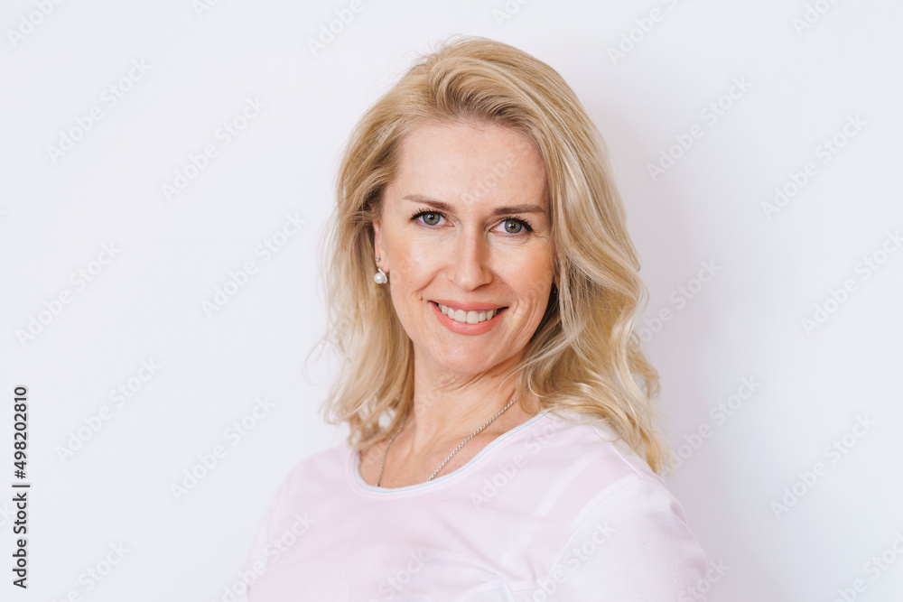 Foto de Beautiful gorgeous middle aged 50s woman looking at camera isolated  on white. Mature elderly woman close up portrait. Healthy beauty face skin  care, middle age skin care cosmetics, cosmetology concept