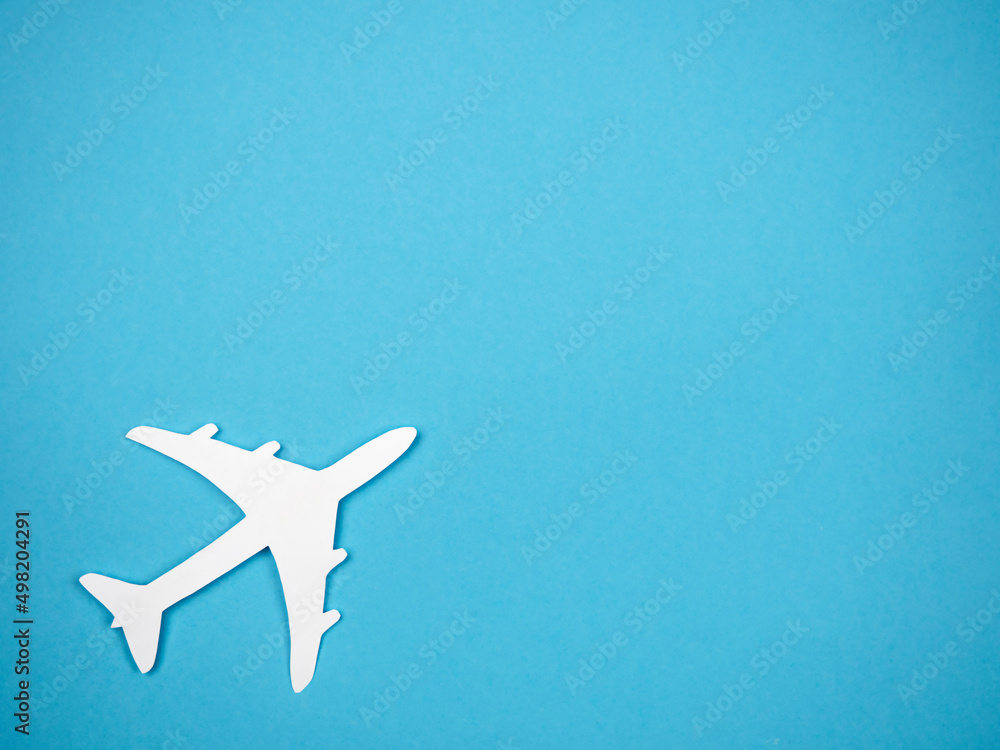 An airliner on a blue background. The concept of travel, rest and flight. An airliner on a blue background. The concept of travel, rest and flight.