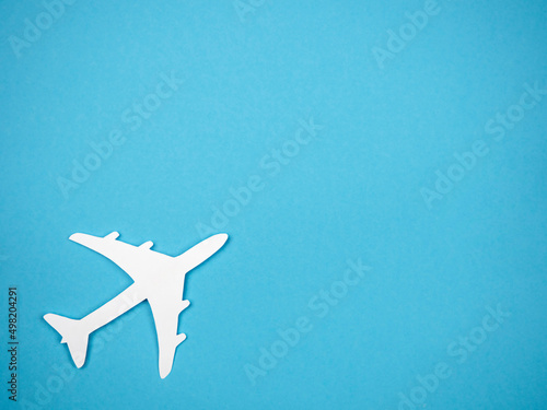 An airliner on a blue background. The concept of travel, rest and flight. © Наталья Майшева