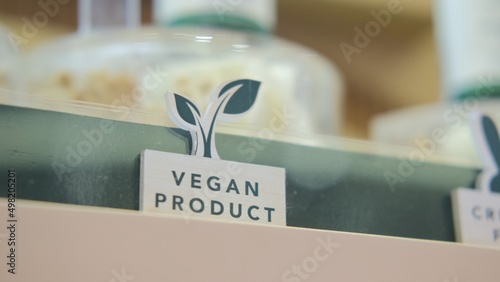 The symbol of a vegan product with a picture in the form of green leaves. Designations of vegan products in the store. Eco shop of ethical cosmetics for conscious people.