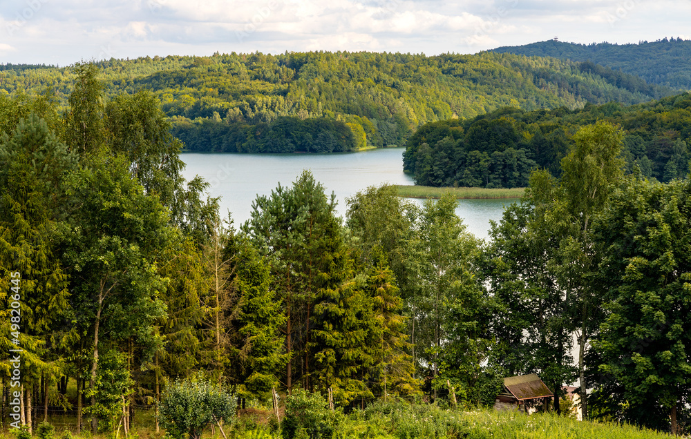Panoramic view of Jezioro Ostrzyckie lake with shores of forest seen from Jastrzebia Gora Hawk Mountain in Ostrzyce village of Kashubia in Pomerania region of Poland
