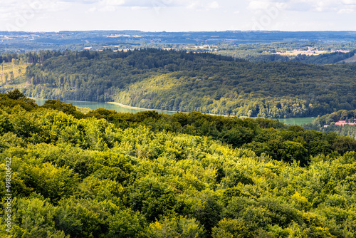 Panorama of summer forest hills and lake valleys of Kashubian landscape park seen from Wiezyca hill observation tower near Szymbark town in Pomerania region of Poland