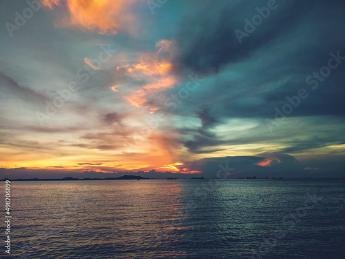 Sunset seascape bright evening sky during sunset with dramatic sky and colorful clouds  © Parichart