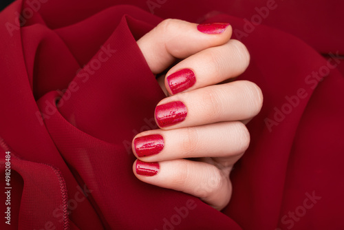 Obraz na plátně Female hand with red nail design