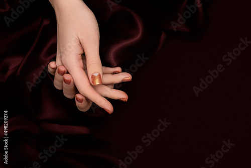Canvas Print Female hands with orange nail design