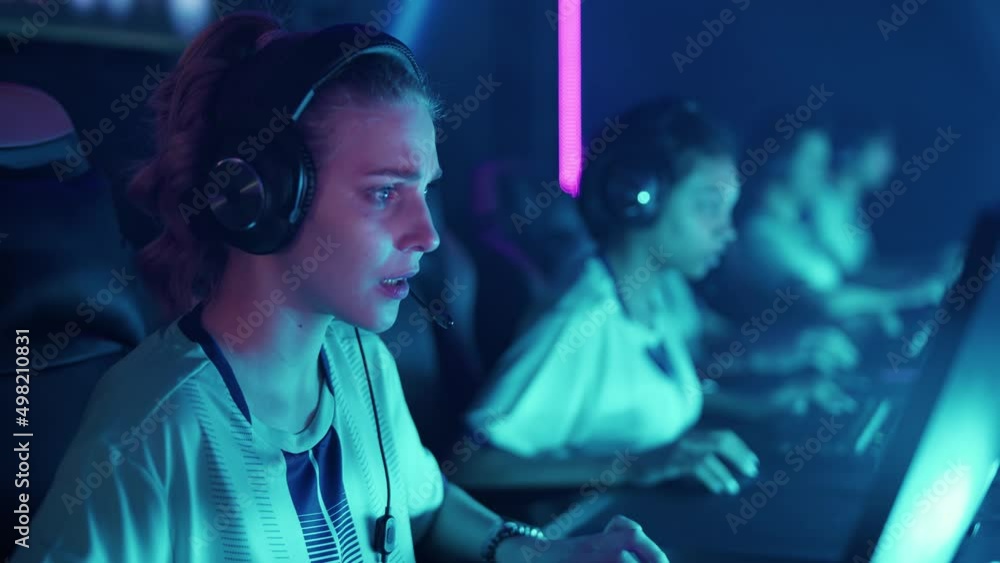 Focused team of gamers in headphones, plays a video game, cyber sportsmans at the international competition game, tense moment, the team won the round, the emotions of victory. Focused team of gamers in headphones, plays a video game, cyber sportsmans at the international competition game, tense moment, the team won the round, the emotions of victory.
