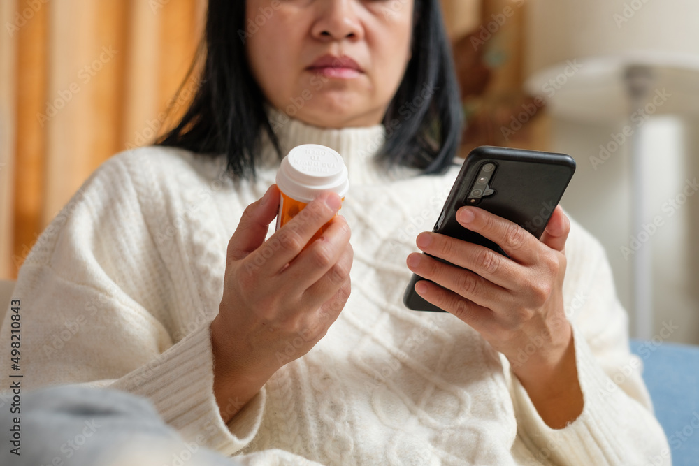 asian woman reading pill prescription when get flu on soaf at home asian woman reading pill prescription when get flu on soaf at home