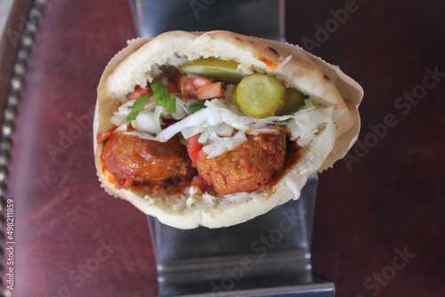 Falafel in pita bread filled with hummus and salads