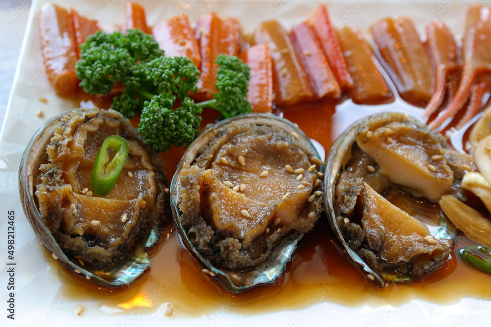 Soy Sauce Marinated Abalone and Soy Sauce Marinated Crabs are served