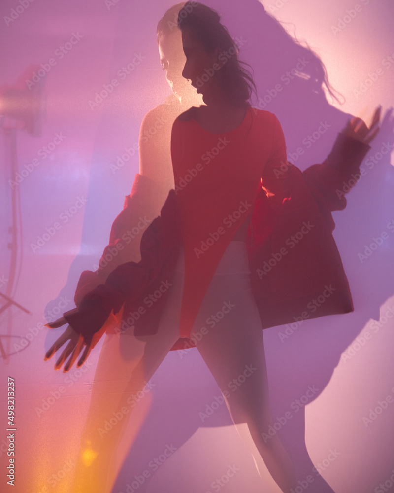 Shadow blur of woman behind the matte glass. Blurry hand, body Figure abstraction, and one palms. The reflection of the silhouette through the light. Vogue trend