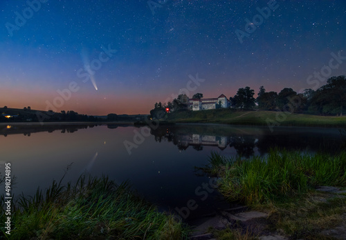Comet C 2020 F3 Neowise in night sky over medieval Svirzh Castle, Lviv region, Ukraine