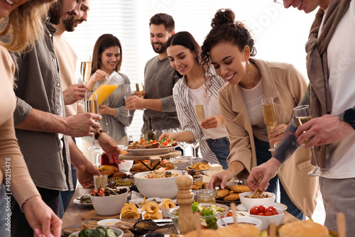 Group of people enjoying brunch buffet together indoors