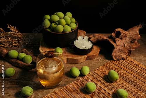 Ingredients for making Homemade plum wine or UMESHU on wooden table with black background.